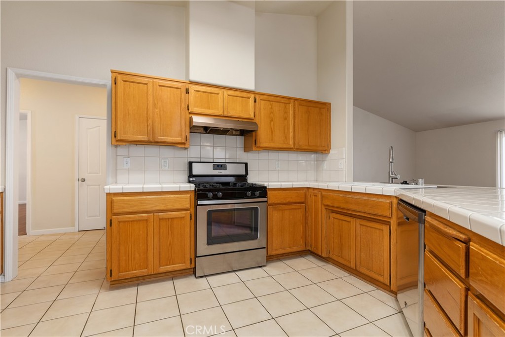 52 Sunnyside Way Templeton, CA 93465 - Photo 11 of 41 a kitchen with stainless steel appliances granite countertop a sink and cabinets