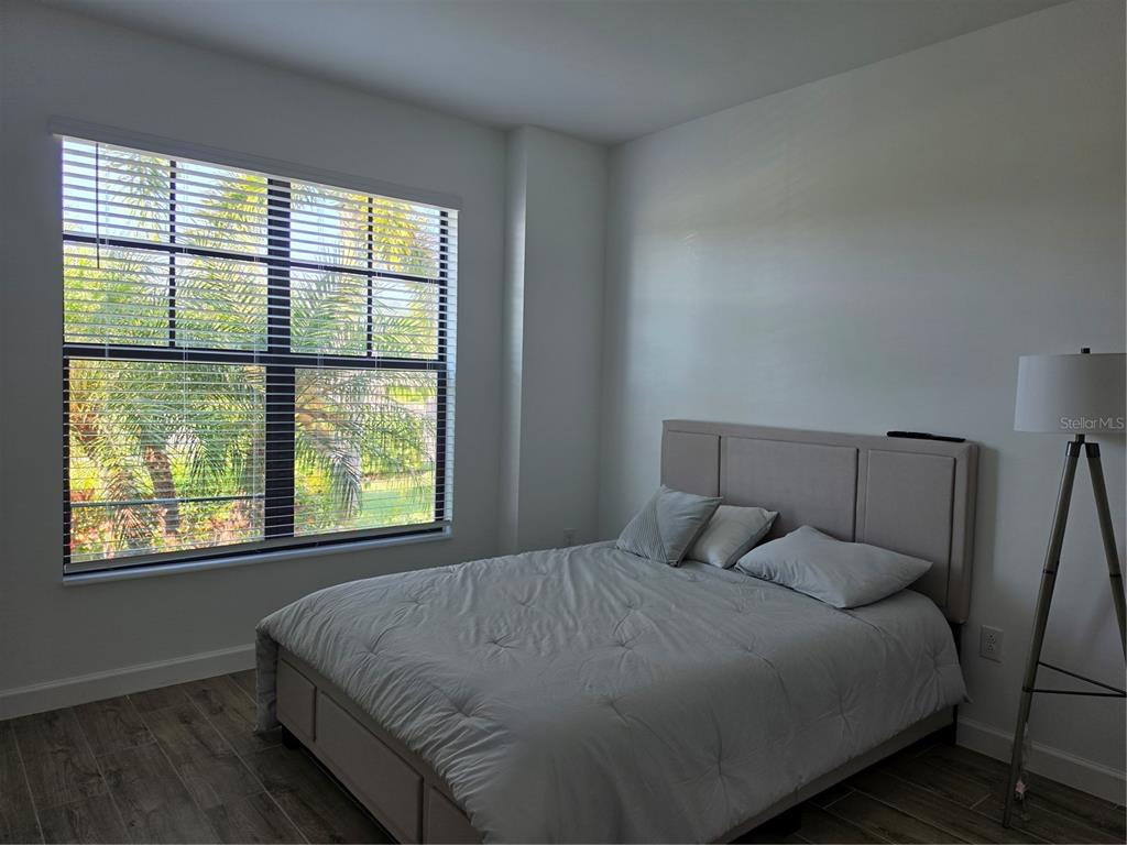 18334 Ridgeline Drive Estero, FL 33928 - Photo 16 of 30 a bed sitting in a bedroom next to a window
