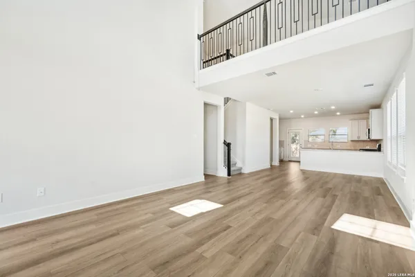 a view of a kitchen with wooden floor and a sink