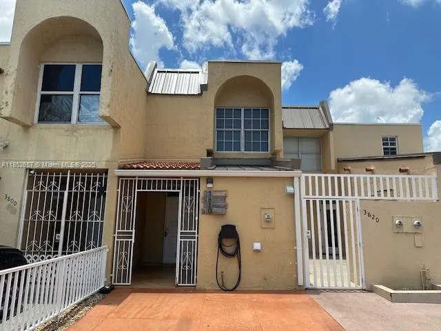 an entrance view of a house with wooden fence