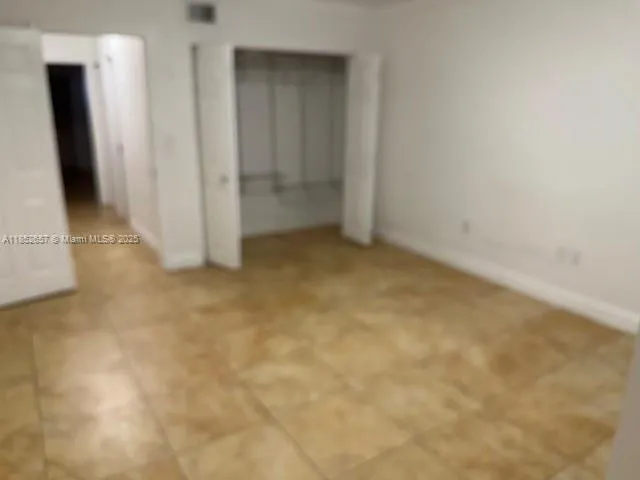 an empty room with wooden floor