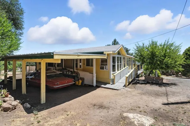 a view of a house with backyard space and porch