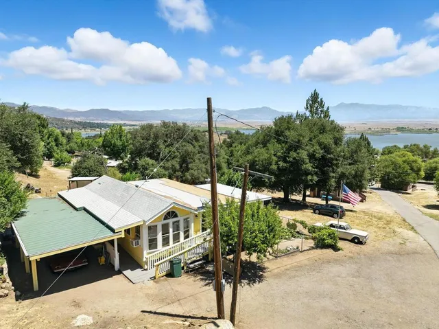 a aerial view of a house with a yard table and chair