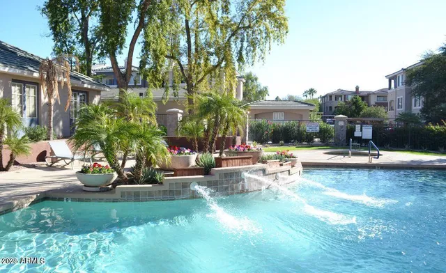 a view of swimming pool with outdoor seating and plants