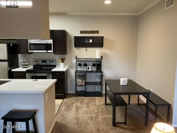 a kitchen with stainless steel appliances a stove microwave and a refrigerator