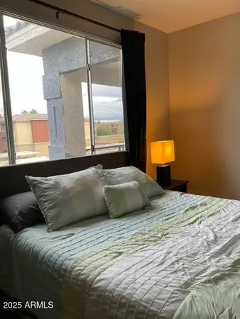 a bedroom with a bed and window