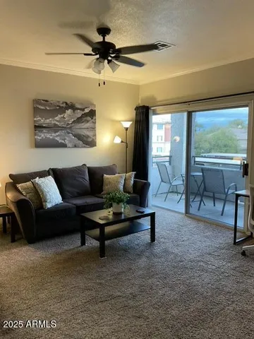 a living room with furniture and a large window
