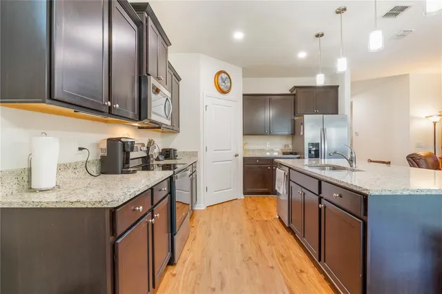 a bathroom with a granite countertop sink a toilet and a mirror