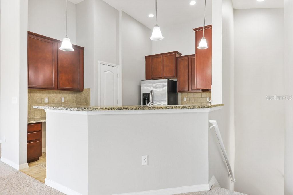 5738 Kingletsound Lithia, FL 33547 - Photo 12 of 32 a bathroom with a granite countertop sink a mirror and a shower