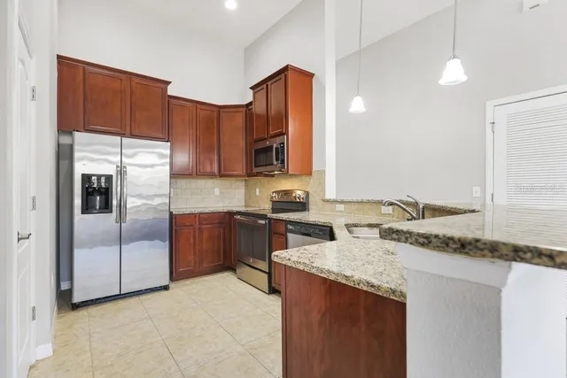 a kitchen with a refrigerator sink and cabinets
