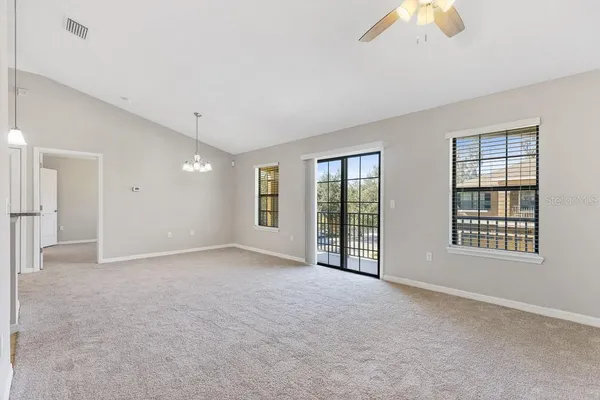 a kitchen with a refrigerator sink and cabinets