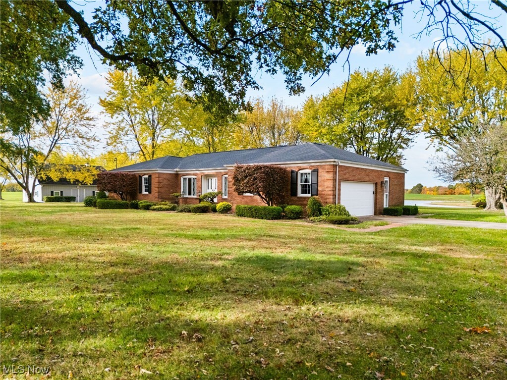 14265 Reeder Avenue Northeast Alliance, OH 44601 - Photo 1 of 39 Ranch-style home with a front lawn, a garage, brick siding, and driveway