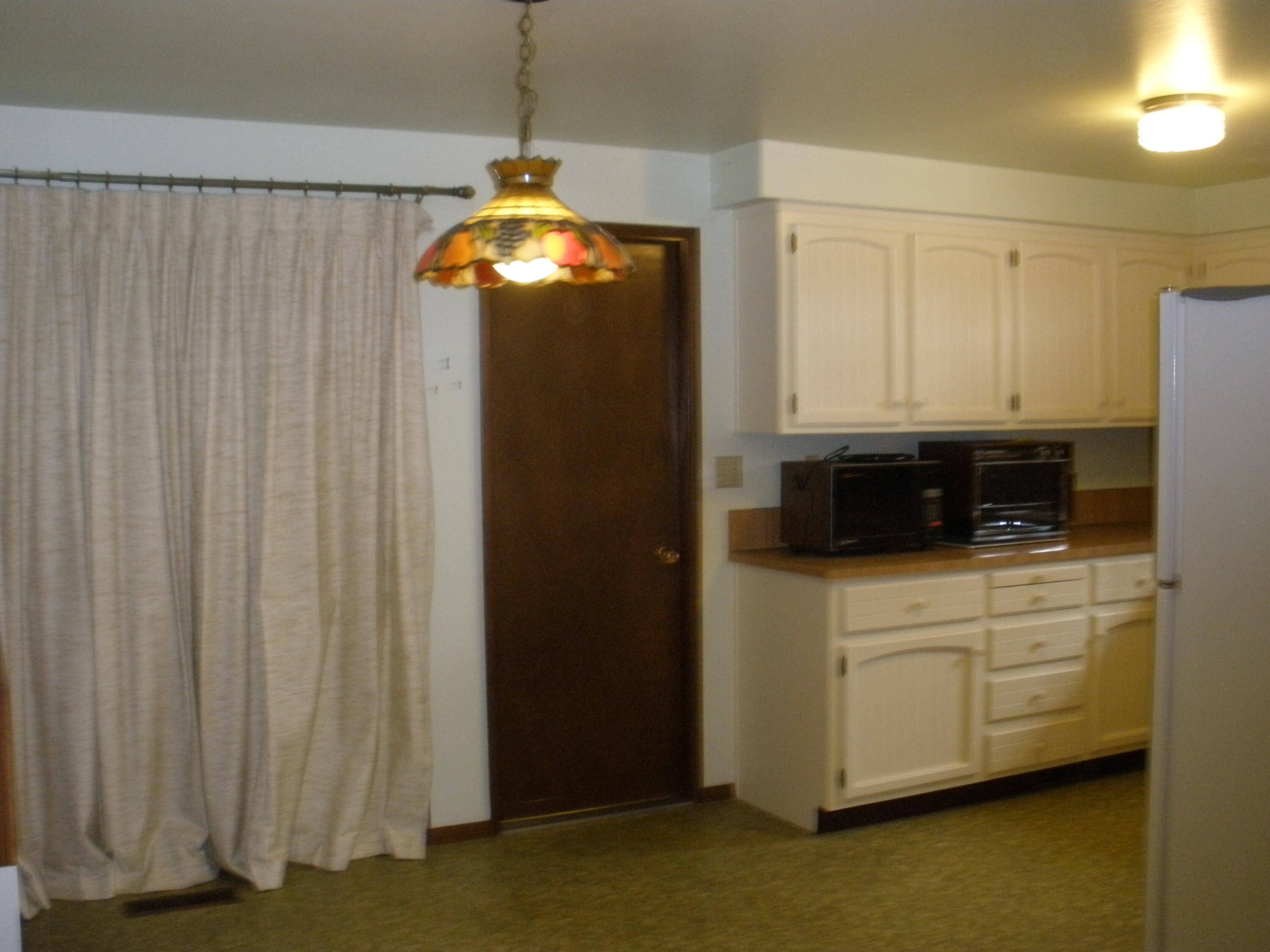 2361 Delta Waters Road Medford, OR 97504 - Photo 13 of 13 Dining and kitchen combo with behind the curtain is the Japanese room area and the door goes to the laundry area and the 2 bedrooms.