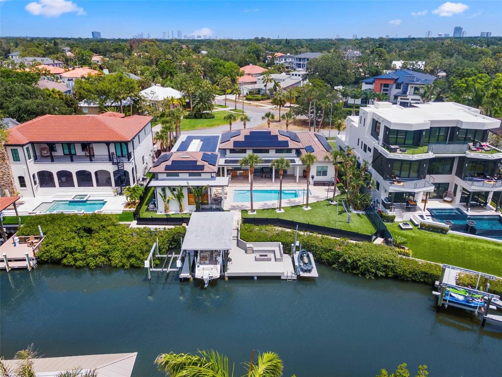 5129 West Neptune Way Tampa, FL 33609 - Photo 11 of 77 an aerial view of a house with a garden and lake view