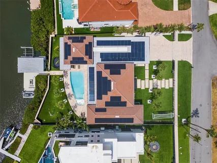a bedroom with bed and a large window