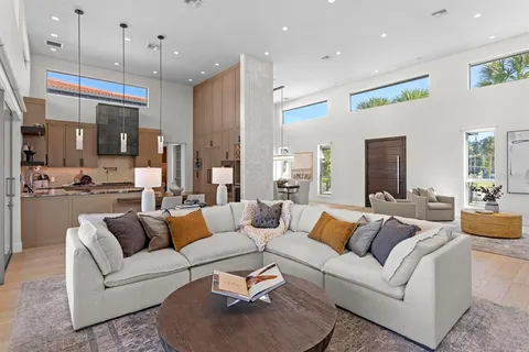 a bathroom with a granite countertop toilet sink and mirror