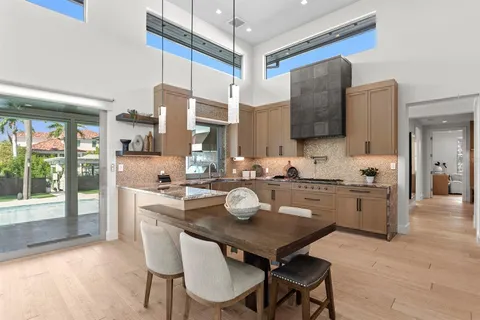 a view of a patio with table and chairs potted plants