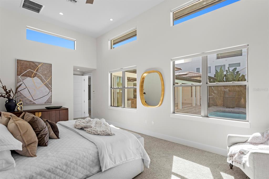 5129 West Neptune Way Tampa, FL 33609 - Photo 36 of 77 a bedroom with a bed and wooden floor