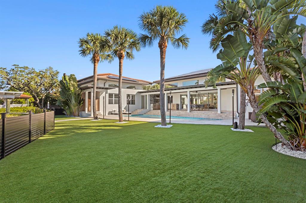 5129 West Neptune Way Tampa, FL 33609 - Photo 62 of 77 a front view of a house with a garden