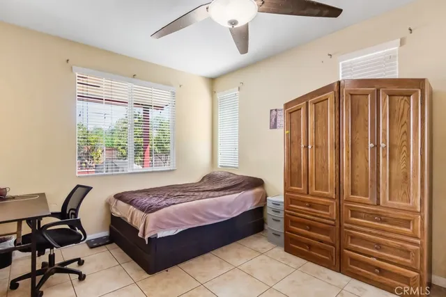 a bed room with a bed and a chair