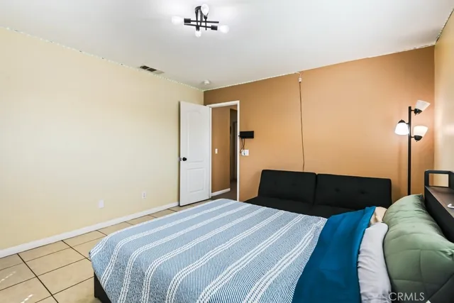 a bedroom with a bed and a lamp