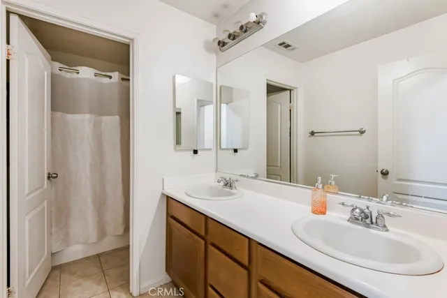 a bathroom with a double vanity sink mirror and double