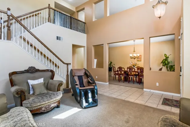 a living room with furniture and a chandelier