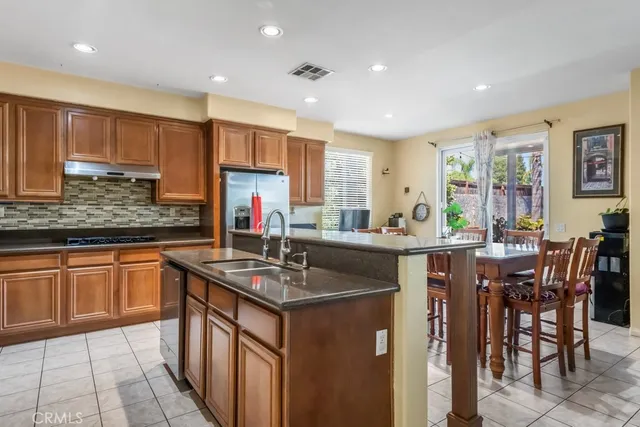 a kitchen with stainless steel appliances granite countertop sink stove and microwave