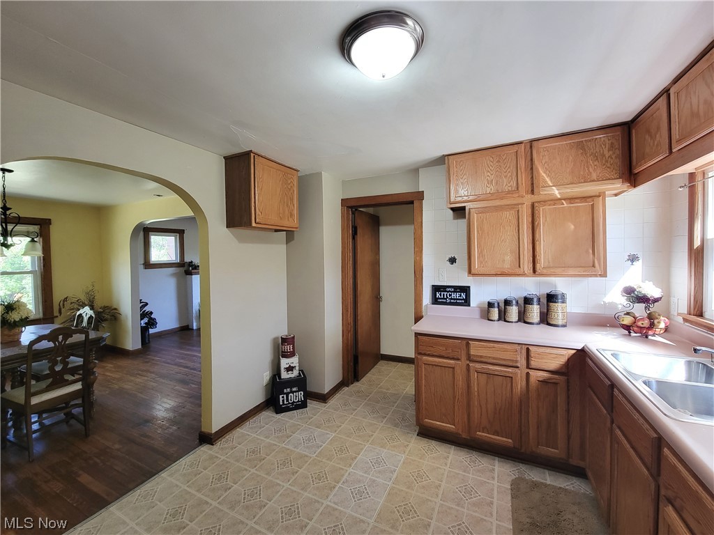 4506 Sandy Lake Road Ravenna, OH 44266 - Photo 11 of 32 Kitchen featuring sink, backsplash, and light tile floors