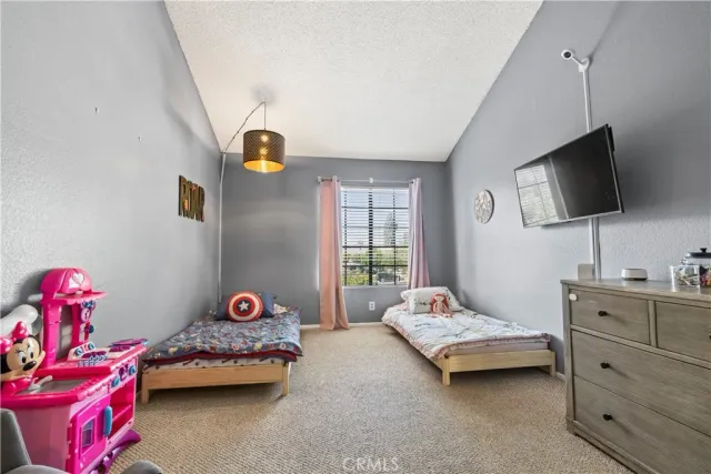 a bedroom with a bed and a tv