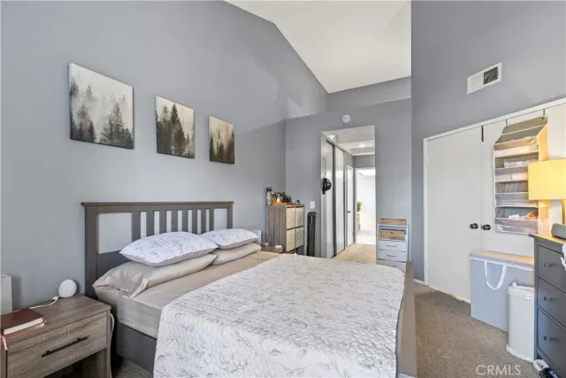 a bedroom with a bed and a couch