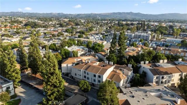 an aerial view of residential houses with outdoor space and trees