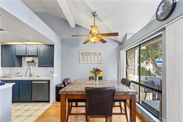 a view of a dining room with furniture a rug and wooden floor