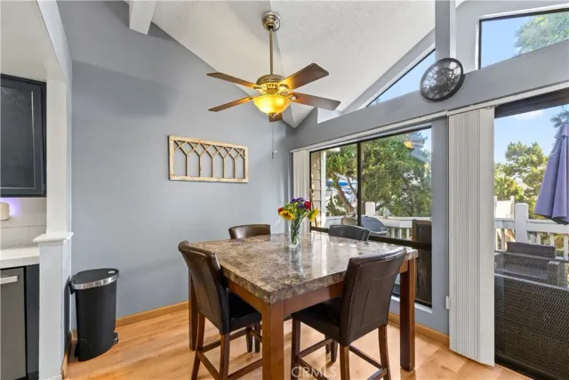 a view of a dining room with furniture a chandelier and wooden floor