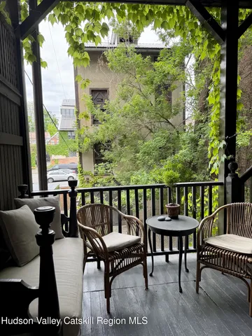 a view of a chairs and table in patio of the house