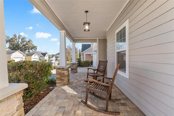 a view of a patio with table and chairs and potted plants