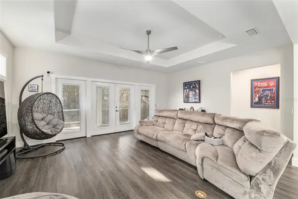 a spacious bedroom with a large bed and a chandelier