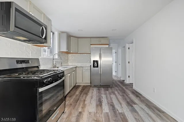 a kitchen with a stove oven and sink