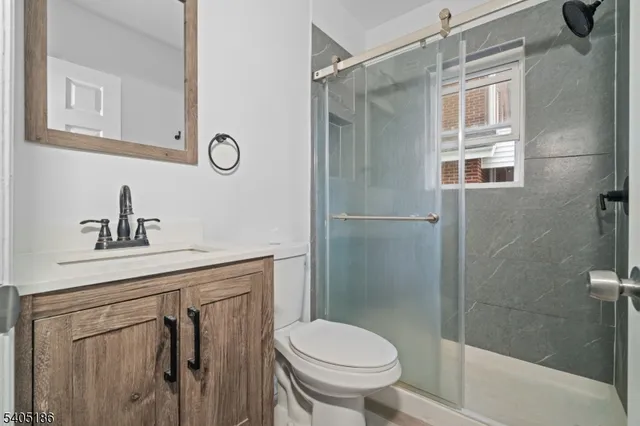 a bathroom with a shower a toilet and a sink