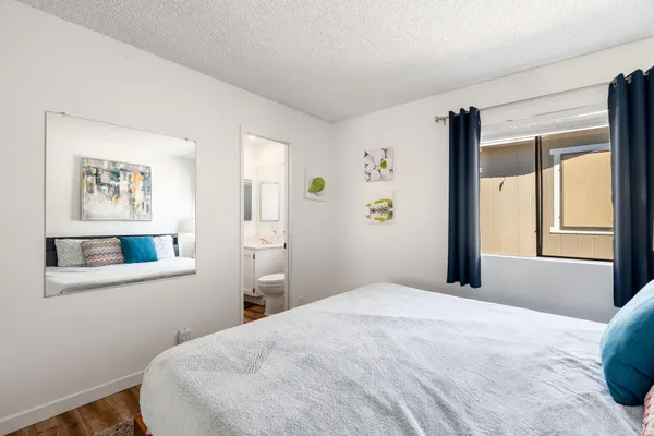 a bedroom with a bed and a window