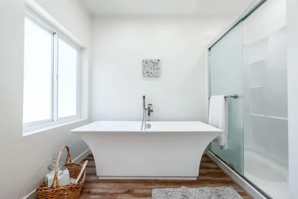 a white bath tub sitting next to a window
