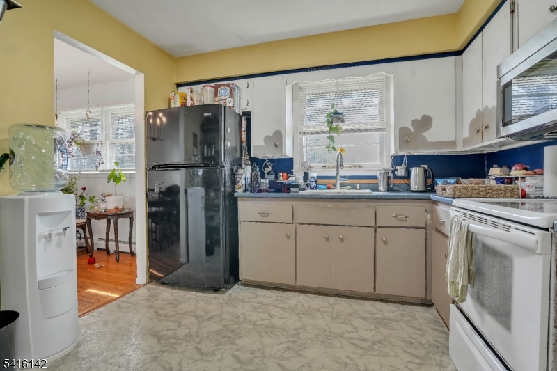 14 Woods Edge Road Stanhope, NJ 07874 - Photo 15 of 25 a kitchen with a refrigerator sink and cabinets