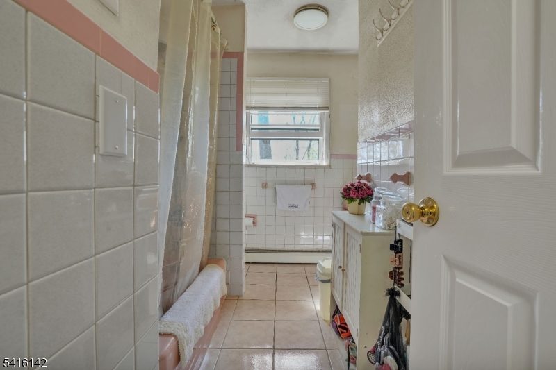 14 Woods Edge Road Stanhope, NJ 07874 - Photo 18 of 25 a bathroom with a tub shower sink and a mirror