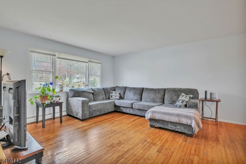14 Woods Edge Road Stanhope, NJ 07874 - Photo 4 of 25 a living room with furniture a ceiling fan and a window