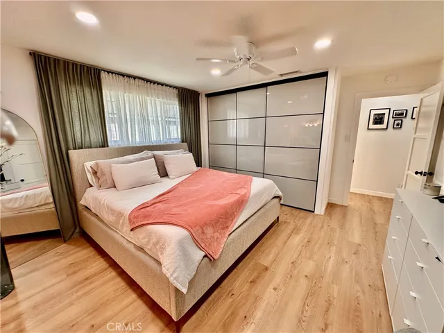 a bedroom with a large bed and a large window