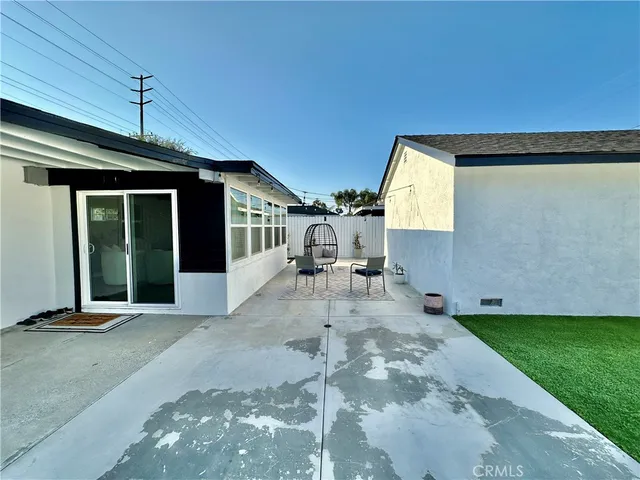 a view of a porch with a table and chairs
