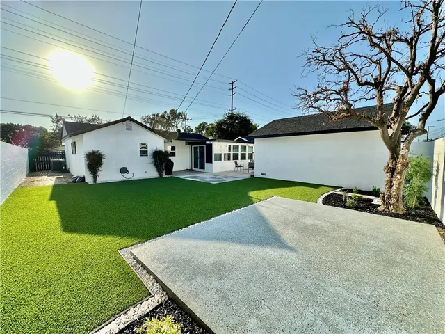 a view of a house with a yard and sitting area