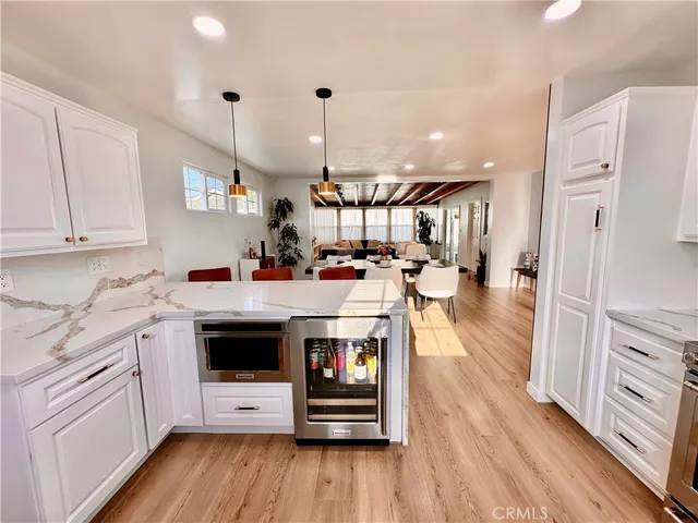 a kitchen with stainless steel appliances a stove a sink and a refrigerator