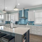 a kitchen with a sink a center island a counter space and a window