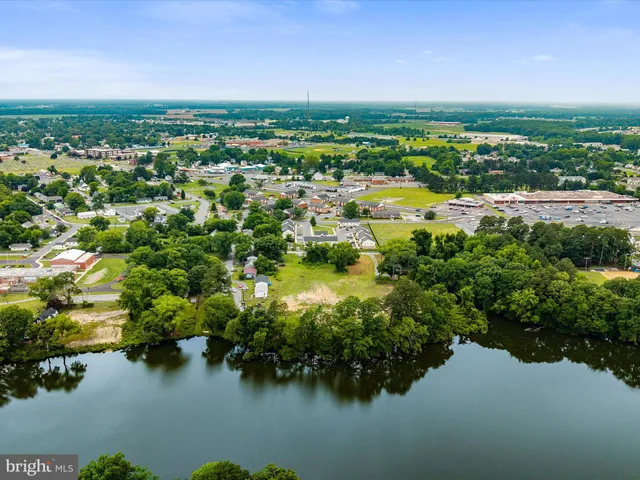 a view of lake with residential houses with outdoor space and swimming pool